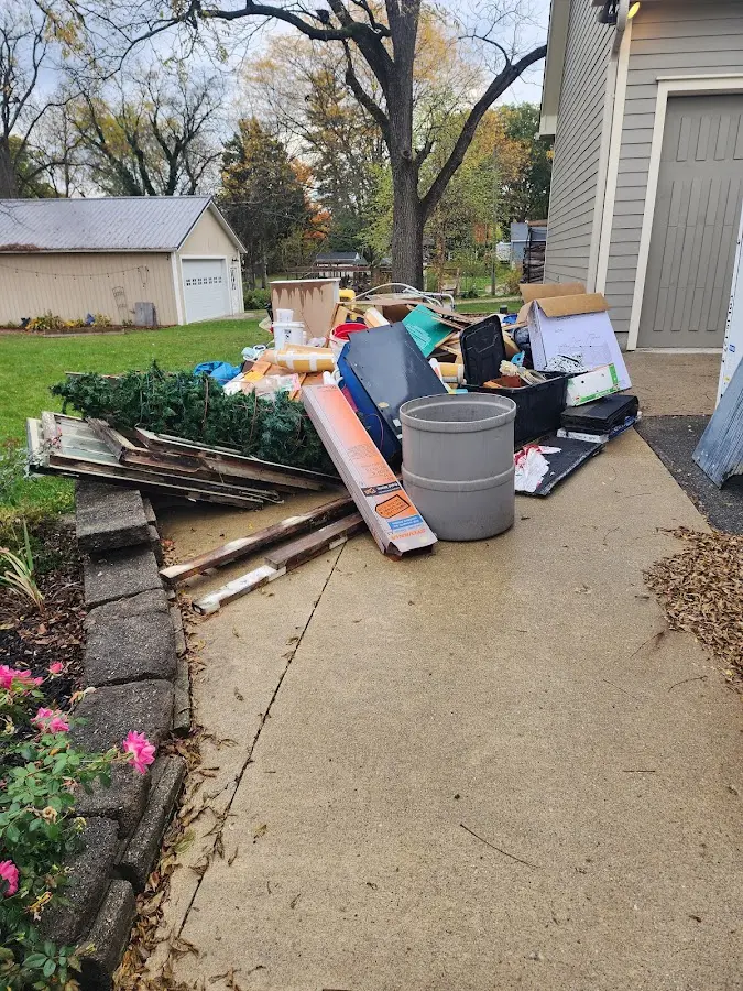 Dumpster being loaded with debris for Roofing Dumpster Rental in Willoughby